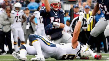 FOXBORO, MA - OCTOBER 29: Tom Brady #12 of the New England Patriots throws as he is tackled by Joey Bosa #99 of the Los Angeles Chargers during the second quarter of a game at Gillette Stadium on October 29, 2017 in Foxboro, Massachusetts. Jim Rogash/Getty Images/AFP
== FOR NEWSPAPERS, INTERNET, TELCOS & TELEVISION USE ONLY ==