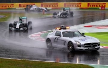SUZUKA, JAPAN - OCTOBER 05:  Nico Rosberg of Germany and Mercedes GP, Lewis Hamilton of Great Britain and Mercedes GP and Valtteri Bottas of Finland and Williams follow the safety car as rain falls during the start of the Japanese Formula One Grand Prix at Suzuka Circuit on October 5, 2014 in Suzuka, Japan.  (Photo by Clive Rose/Getty Images)