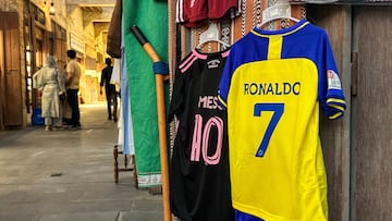 The football jerseys of Portugal's forward #7 Cristiano Ronaldo with his new Saudi club al-Nassr and Argentina's forward #10 Lionel Messi with his new US club Inter Miami CF are displayed for sale at a vendor's stall at Qatar's touristic Souq Waqif bazar in Doha on August 7, 2023. (Photo by KARIM JAAFAR / AFP)