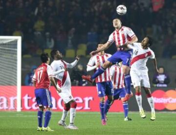 Peru's forward Andre Carrillo (R) and Paraguay's forward Raul Bobadilla (2-R) jump for the ball next to Paraguay's midfielder Victor Caceres (C), Paraguay's midfielder Osvaldo Martinez (L) and Peru's midfielder Carlos Ascues (2-L) during the Copa America third place football match in Concepcion, Chile on July 3, 2015.