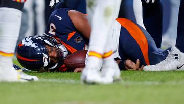 DENVER, COLORADO - DECEMBER 11: Russell Wilson #3 of the Denver Broncos lies on the field after sustaining a concussion in the fourth quarter of a game against the Kansas City Chiefs at Empower Field At Mile High on December 11, 2022 in Denver, Colorado.   Justin Edmonds/Getty Images/AFP (Photo by Justin Edmonds / GETTY IMAGES NORTH AMERICA / Getty Images via AFP)