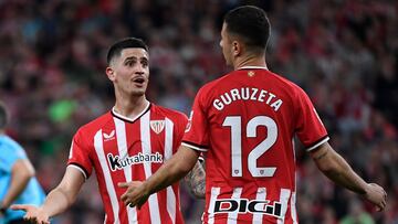 Athletic Bilbao's Spanish midfielder #08 Oihan Sancet (L) talks to Athletic Bilbao's Spanish forward #12 Gorka Guruzeta during the Spanish league football match between Athletic Club Bilbao and Granada FC at the San Mames stadium in Bilbao on April 19, 2024. (Photo by ANDER GILLENEA / AFP)