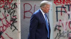 FILE PHOTO: U.S. President Donald Trump walks past a building defaced with graffiti by protestors in Lafayette Park across from the White House while walking to St John&#039;s Church for a photo opportunity during ongoing protests over racial inequality i