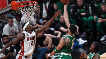 Boston Celtics forward Jayson Tatum (0) shoots against Miami Heat forward Jimmy Butler (22).