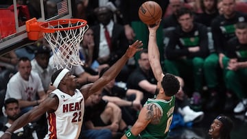 Boston Celtics forward Jayson Tatum (0) shoots against Miami Heat forward Jimmy Butler (22).