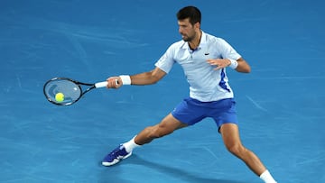 Serbia's Novak Djokovic hits a return against Croatia's Dino Prizmic during their men's singles match on day one of the Australian Open tennis tournament in Melbourne on January 14, 2024. (Photo by Martin KEEP / AFP) / -- IMAGE RESTRICTED TO EDITORIAL USE - STRICTLY NO COMMERCIAL USE --