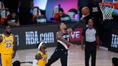 Portland Trail Blazers guard Damian Lillard (0) goes to the basket over Los Angeles Lakers guard Kentavious Caldwell-Pope (1) during the first half of an NBA basketball game Tuesday, Aug. 18, 2020, in Lake Buena Vista, Fla. (AP Photo/Ashley Landis, Pool)