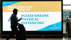 A passenger walks past a social distancing sign at Cape Town International Airport, run by state-controlled airports company ACSA, during the coronavirus disease (COVID-19) outbreak in Cape Town, South Africa, July 7, 2020. Picture taken July 7, 2020. REU