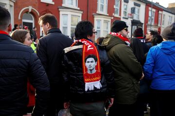 A Liverpool fans with a Takumi Minamino scarf outside Anfield before kick-off