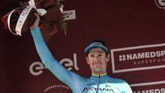 Denmark&#039;s Jakob Fuglsang celebrates on the podium after placing second of the one-day classic cycling race Strade Bianche (White Roads) on March 9, 2019 in Siena, Tuscany. (Photo by Marco BERTORELLO / AFP)