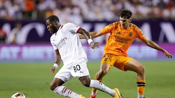 AC Milan's midfielder #80 Yunus Musah (L) goes past Real Madrid's midfielder #28 Mario Mart�n (R) during the second half of the pre-season club friendly football match between AC Milan and Real Madrid at Soldier Field in Chicago, Illinois, on July 31, 2024. (Photo by KAMIL KRZACZYNSKI / AFP)