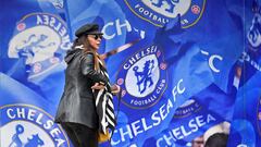 A woman walks past a Chelsea merchandise store at Stamford Bridge, the stadium for Chelsea Football Club, after Russian businessman Roman Abramovich said on Wednesday that he would sell Chelsea, 19 years after buying it, amid growing pressure for oligarch