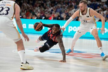 Codi Miller-McIntyre aguanta el control del balón pese a su caída con Dzanan Musa atento a su defensa.
