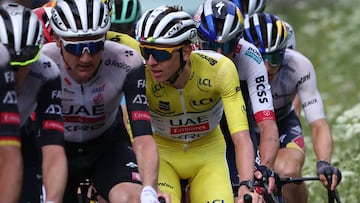UAE Team Emirates XRG's Slovenian rider Tadej Poga?ar wearing the overall leader's yellow jersey (C) cycles during the 8th and final stage of the 77th edition of the Criterium du Dauphine cycling race, 133,3 km between Val-d'Arc and Val-Cenis - Plateau du Mont Cenis, on June 15, 2025. (Photo by Anne-Christine POUJOULAT / AFP)