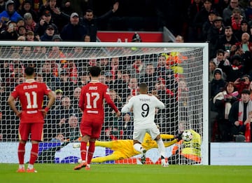 Liverpool goalkeeper Caoimhin Kelleher (rear) saves a penalty from Real Madrid's Kylian Mbappe (right) 