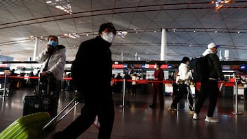 Travellers walk with luggages at a terminal hall, during the annual Spring Festival travel rush ahead of the Chinese Lunar New Year, as the coronavirus disease (COVID-19) outbreak continues, in Beijing Capital International Airport, Beijing, China January 18, 2023. REUTERS/Tingshu Wang