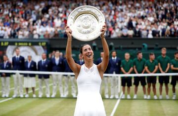 Tennis - Wimbledon - London, Britain - July 15, 2017 Spain’s Garbine Muguruza poses with the trophy as she celebrates winning the final against Venus Williams of the U.S.