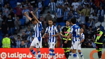 (From L) Real Sociedad's Spanish forward Carlos Fernandez, Real Sociedad's Spanish midfielder Brais Mendez and Real Sociedad's Japanese forward Takefusa Kubo celebrate victory with teammates at the end of the Spanish league football match between Real Sociedad and Rayo Vallecano at the Reale Arena stadium in San Sebastian on April 22, 2023. (Photo by ANDER GILLENEA / AFP)