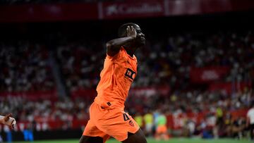 Valencia's Guinean defender #04 Mouctar Diakhaby celebrates scoring his team's first goal during the Spanish Liga football match between Sevilla FC and Valencia CF at the Ramon Sanchez Pizjuan stadium in Seville on August 11, 2023. (Photo by CRISTINA QUICLER / AFP)