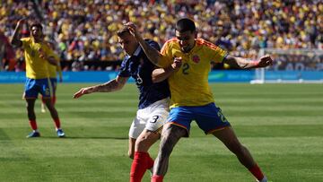 France's defender #03 Lucas Digne and Colombia's defender #02 Daniel Munoz fight for the ball during a friendly football match between Colombia and France at Northwest Stadium in Landover, Maryland, on March 29, 2026. (Photo by FRANCK FIFE / AFP)