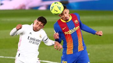 Soccer Football - La Liga Santander - Real Madrid v FC Barcelona - Estadio Alfredo Di Stefano, Madrid, Spain - April 10, 2021 Barcelona's Clement Lenglet in action with Real Madrid's Federico Valverde REUTERS/Sergio Perez
