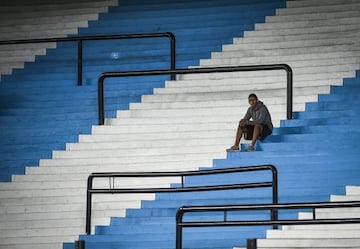 A ballboy waits in the empty stands of Presidente Peron Stadium prior to a Group F match between Racing Club and Alianza Lima as part of Copa CONMEBOL Libertadores 2020