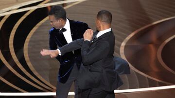 Will Smith (R) hits Chris Rock as Rock spoke on stage during the 94th Academy Awards in Hollywood, Los Angeles, California, U.S., March 27, 2022. Picture taken March 27, 2022. REUTERS/Brian Snyder BEST AVAILABLE QUALITY