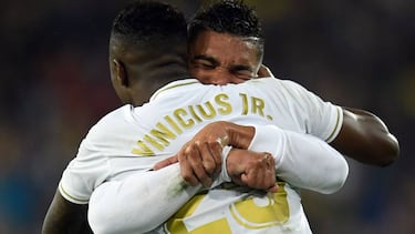 Real Madrid's Brazilian forward Vinicius Junior is congratulated by Real Madrid's Brazilian midfielder Casemiro during the Spanish League football match between Real Madrid and Barcelona at the Santiago Bernabeu stadium in Madrid on March 1, 202