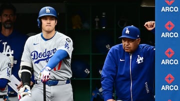 May 28, 2025; Cleveland, Ohio, USA; Los Angeles Dodgers designated hitter Shohei Ohtani (17) waits next to manager Dave Roberts (30) for his turn to bat during the ninth inning against the Cleveland Guardians at Progressive Field. Mandatory Credit: Ken Blaze-Imagn Images
