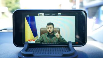 President Zelensky of Ukraine's address to the Oireachtas is displayed on a mobile phone outside Leinster House, Dublin. Picture date: Wednesday April 6, 2022. (Photo by Niall Carson/PA Images via Getty Images)