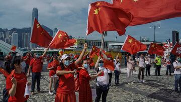 HONG KONG, CHINA - OCTOBER 01: Pro-China supporters display People&#039;s Republic of China flags to mark China&#039;s National Day on October 1, 2020 in Hong Kong, China. Hong Kong police deployed 6000 officers on National Day to handle any chaos that mi