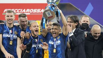 Inter Milan's Alexis Sanchez holds the trophy as he celebrates with his teammates after winning the Italian Super Cup final soccer match between Inter Milan and Juventus at the San Siro Stadium, in Milan, Italy, Wednesday, Jan. 12, 2022. Inter Milan