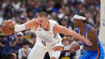 Denver Nuggets center Nikola Jokic, left, struggles to control the ball as Oklahoma City Thunder guard Shai Gilgeous-Alexander defends in the second half of Game 6 in the Western Conference semifinals of the NBA basketball playoffs Thursday, May 15, 2025, in Denver. (AP Photo/David Zalubowski)