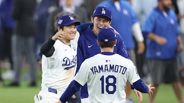 Oct 27, 2025; Los Angeles, California, USA; Los Angeles Dodgers designated hitter Shohei Ohtani (17) celebrates with pitcher Roki Sasaki (11) and pitcher Yoshinobu Yamamoto (18) after winning in the eighteenth inning against the Toronto Blue Jays in game three of the 2025 MLB World Series at Dodger Stadium. Mandatory Credit: Kiyoshi Mio-Imagn Images