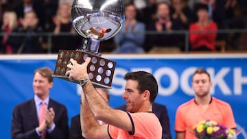 Juan Martin Del Potro reacts as he lifts the heavy trophy during an award ceremony after defeating USA's Jack Sock at the ATP Stockholm Open tennis tournament final match on October 23, 2016 in Stockholm. / AFP PHOTO / JONATHAN NACKSTRAND