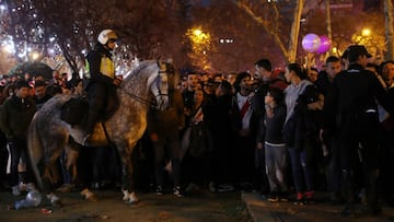 Soccer Football - Copa Libertadores Final - Second Leg - River Plate v Boca Juniors - Santiago Bernabeu, Madrid, Spain - December 9, 2018  River Plate fans and a mounted police officer outside the stadium before the match   REUTERS/Susana Vera