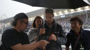 Jenson Button firma aut&oacute;grafos en el circuito de Suzuka.