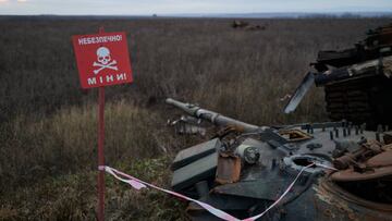 IZYUM, UKRAINE - DECEMBER 22: A warning sign for mines is seen near a Russian tank hit by an anti-tank missile on December 22, 2022 in Izyum, Ukraine. (Photo by Pierre Crom/Getty Images)