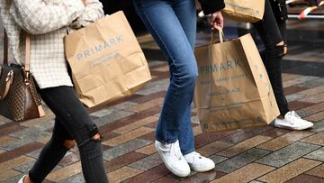 FILE PHOTO: People carry Primark shopping bags after retail restrictions due to coronavirus disease (COVID-19) eased, in Belfast, Northern Ireland, May 4, 2021. REUTERS/Clodagh Kilcoyne/File Photo