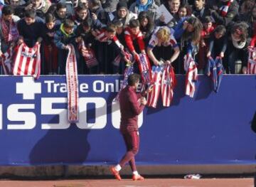 Simeone firma autógrafos a los aficionados.