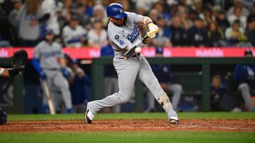 Sep 27, 2025; Seattle, Washington, USA; Los Angeles Dodgers second baseman Miguel Rojas (72) hits a double against the Seattle Mariners during the fifth inning at T-Mobile Park. Mandatory Credit: Steven Bisig-Imagn Images
