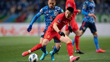 China&#039;s Wu Lei (front) and Japan&#039;s Yuto Nagatomo compete for the ball during the FIFA World Cup Qatar 2022 Asian zone qualification football match between Japan and China at Saitama Stadium in Saitama on January 27, 2022. (Photo by Philip FONG /