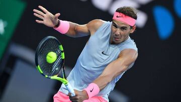 Spain's Rafael Nadal hits a return against Dominican Republic's Victor Estrella Burgos during their men's singles first round match on day one of the Australian Open tennis tournament in Melbourne on January 15, 2018. / AFP PHOTO / Greg Woo