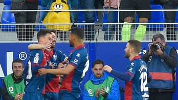 Huesca's Venezuelan midfielder Juanpi (L) celebrates after scoring a goal during the Spanish league football match between SD Huesca and Sevilla FC at the El Alcoraz stadium in Huesca on March 2, 2019. (Photo by ANDER GILLENEA / AFP)