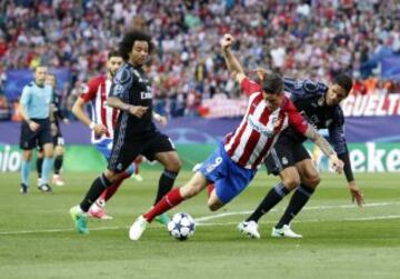 Raphael Varane brings down Atlético striker Fernando Torres to concede a penalty.