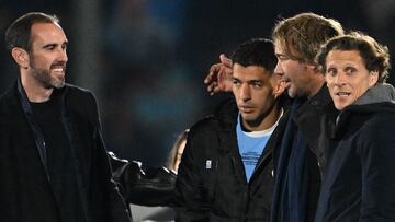 Uruguay's forward Luis Suarez (2nd L) greets former teammates (L to R) Diego Godin, Diego Lugano, and Diego Forlan during his farewell ceremony to the national team after the 2026 FIFA World Cup South American qualifiers football match between Uruguay and Paraguay at the Centenario stadium in Montevideo, on September 6, 2024. (Photo by Eitan ABRAMOVICH / AFP)