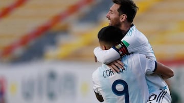 Argentina's Joaquin Correa celebrates with teammate Lionel Messi (top) after scoring against Bolivia during their 2022 FIFA World Cup South American qualifier football match at the Hernando Siles Stadium in La Paz on October 13, 2020, amid the COVID-