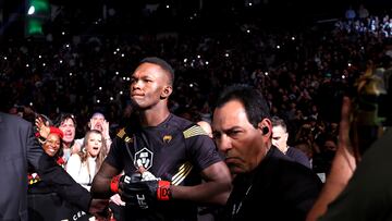 HOUSTON, TEXAS - FEBRUARY 12: Israel Adesanya of Nigeria enters the octagon for his middleweight championship fight against Robert Whittaker of Australia during UFC 271 at Toyota Center on February 12, 2022 in Houston, Texas.   Carmen Mandato/Getty Images/AFP
== FOR NEWSPAPERS, INTERNET, TELCOS & TELEVISION USE ONLY ==