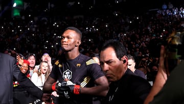 HOUSTON, TEXAS - FEBRUARY 12: Israel Adesanya of Nigeria enters the octagon for his middleweight championship fight against Robert Whittaker of Australia during UFC 271 at Toyota Center on February 12, 2022 in Houston, Texas.   Carmen Mandato/Getty Images/AFP
== FOR NEWSPAPERS, INTERNET, TELCOS & TELEVISION USE ONLY ==