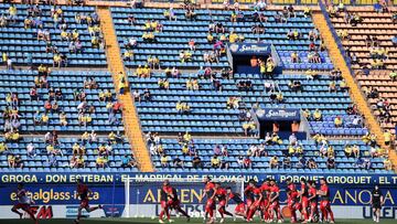 VILLAREAL, SPAIN - MAY 16: Sevilla FC warm up as fans are seen in the stands prior to the La Liga Santander match between Villarreal CF and Sevilla FC at Estadio de la Ceramica on May 16, 2021 in Villareal, Spain. Villarreal will host 5,000 fans in the st
